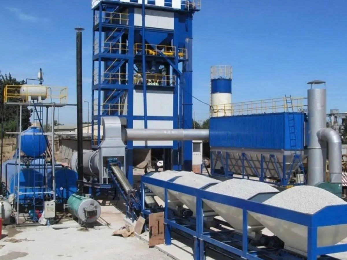 Stationary asphalt batch mix plant with mixing tower, baghouse and cold feed bins